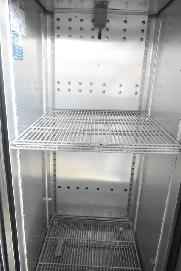 Interior view of a commercial-grade True reach-in cooler with wire shelving, part of a Southern Dimensions 24' trailer.