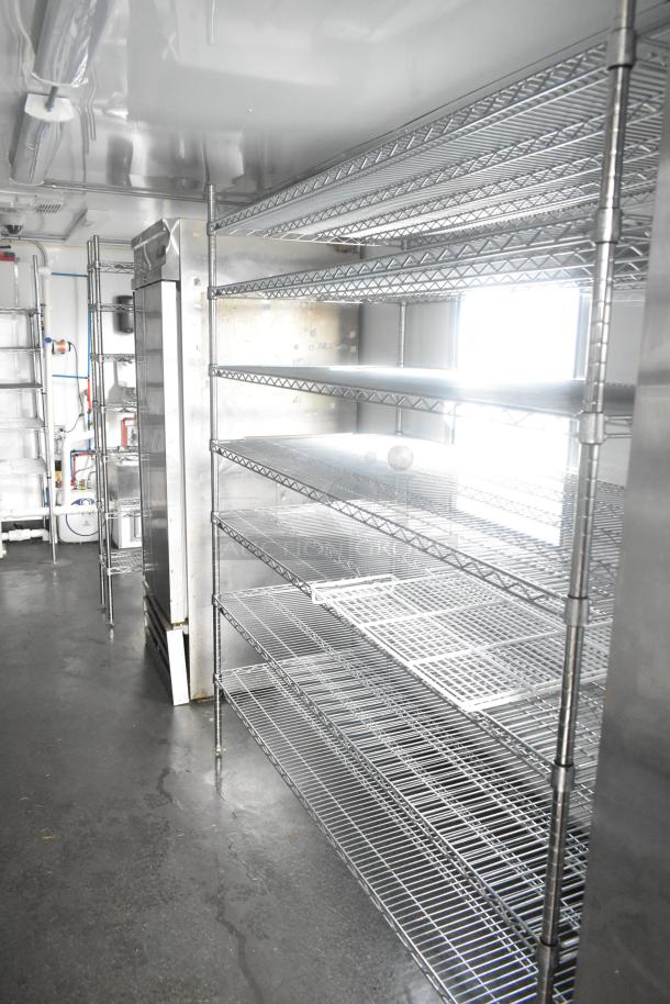 Southern Dimensions 24' cold food trailer interior with wire shelving, commercial sinks, and True coolers visible.