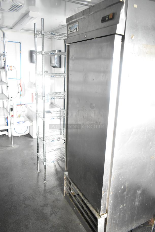 Southern Dimensions 24' trailer interior with Avanti cooler, wire shelving, and sinks. Ideal for food service setup.