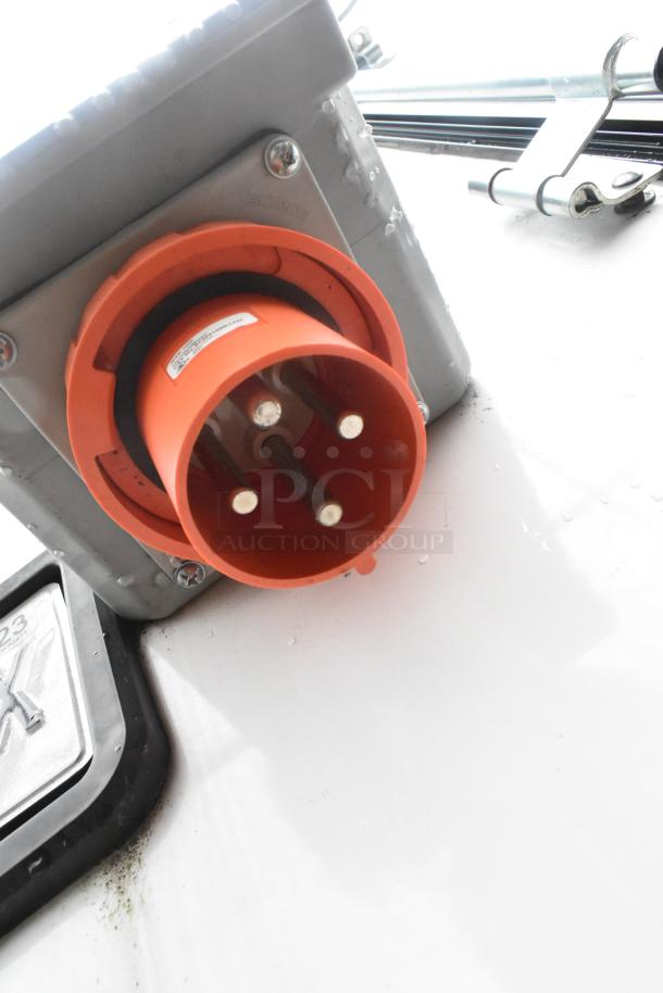 Close-up of an orange electrical plug on a Southern Dimensions 24' cold food trailer.