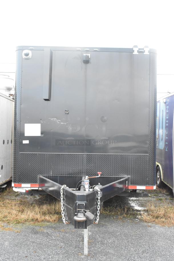 Southern Dimensions 24' unbranded cold food trailer, black exterior, equipped with commercial-grade coolers and freezers.