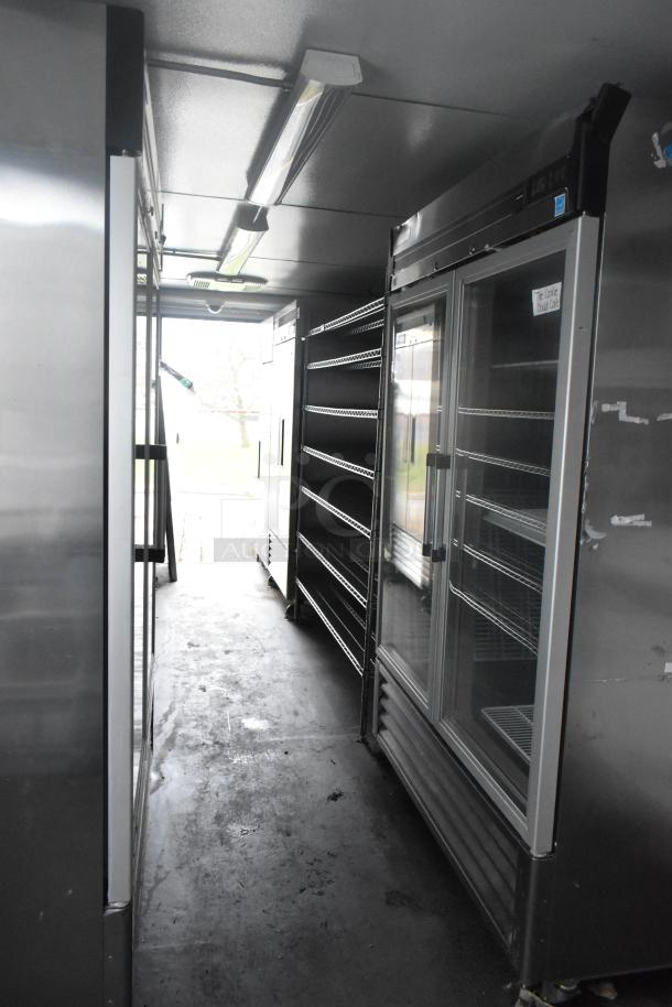 Southern Dimensions 24' food trailer with Norlake coolers, Turbo Air freezers, sinks, and shelving. Ideal for food service.