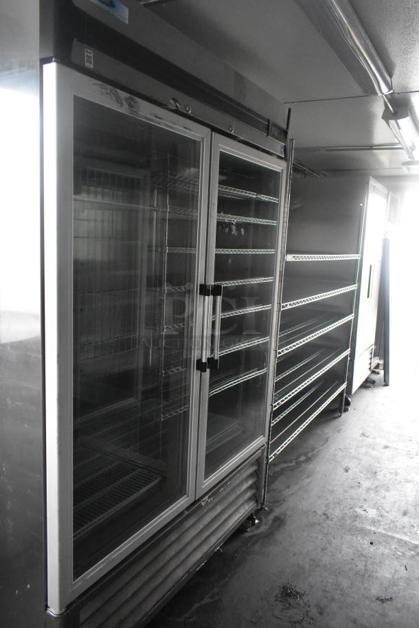 Southern Dimensions 24' trailer interior showing Norlake 2-door coolers and wire shelving units. Commercial-grade setup.