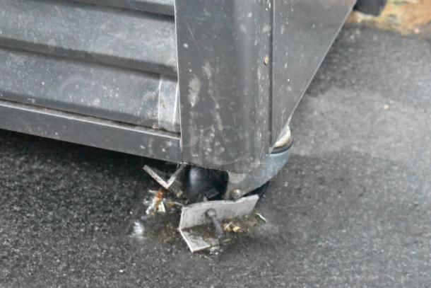 Damaged corner of a Southern Dimensions 24' food trailer, showing a bent metal bracket and wheel beneath.