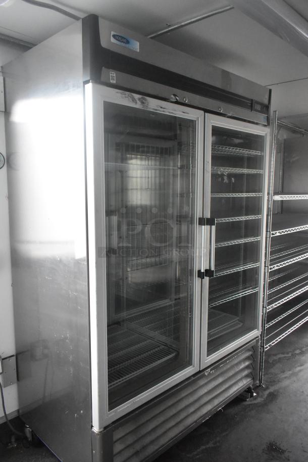 Norlake 2 Door Commercial Cooler with glass doors, wire shelving inside. Stainless steel, ideal for food and beverage storage.