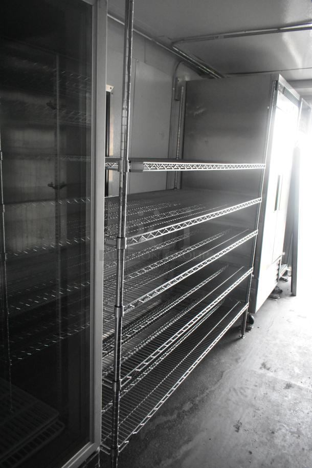 Southern Dimensions 24' cold food & beverage trailer interior with wire shelving and Norlake 2-door cooler. Excellent condition.