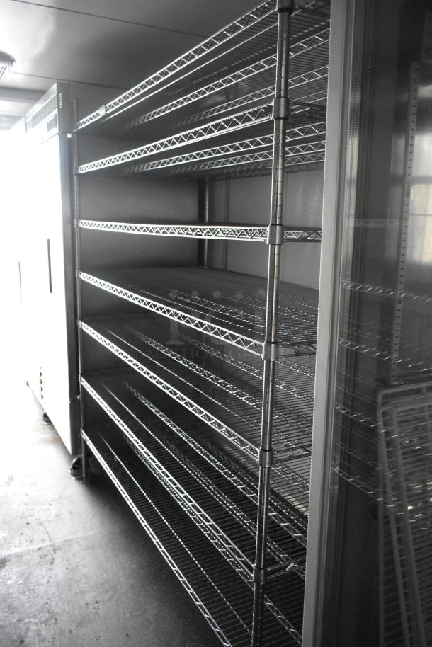 Southern Dimensions 24' retail trailer interior showing wire shelving units, Norlake coolers, and Turbo Air freezers.