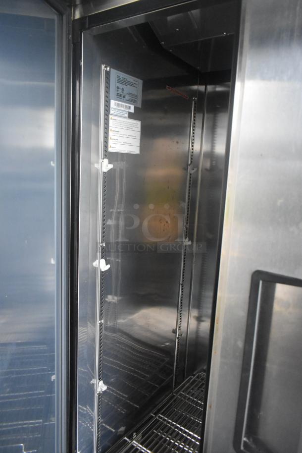 Alt text: Interior of Southern Dimensions 24' trailer showing Norlake 2-door cooler. Features wire shelving and labels with specs.