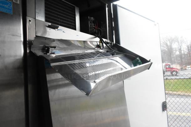 Interior view of Southern Dimensions 24' retail trailer, showing stainless steel equipment and ventilation system.