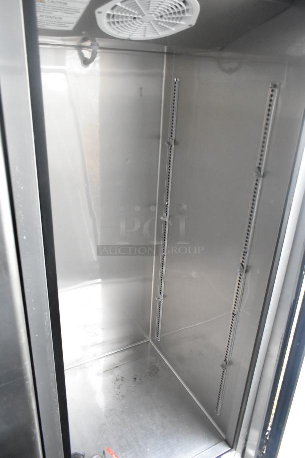 Interior view of stainless steel commercial cooler in new 2021 Southern Dimensions 24' retail trailer. Features shelves and vent.