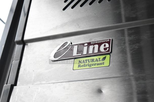 A stainless steel panel with "e Line Refrigerator" and "Natural Refrigerant" labels, indicating eco-friendly features.
