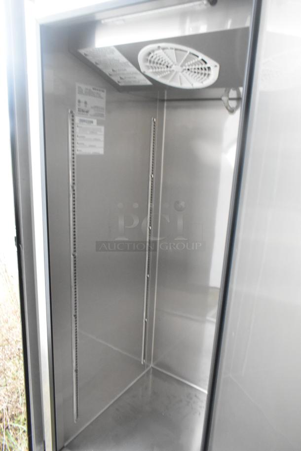 Interior view of Norlake 2-door cooler in excellent condition, featuring stainless steel walls and a top-mounted fan.