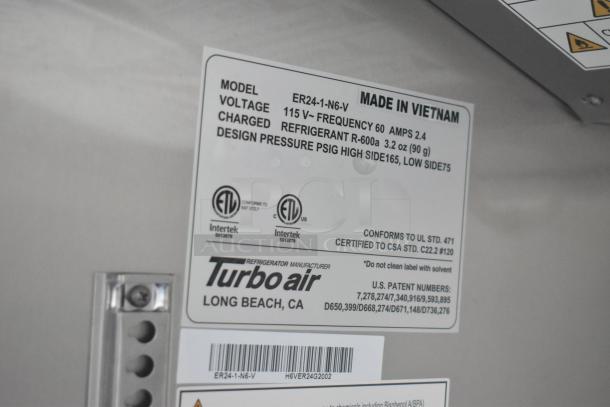 Label on Turbo Air fridge in Southern Dimensions trailer. Details model ER24-1-N6-V, voltage 115V, refrigerant R-600a.