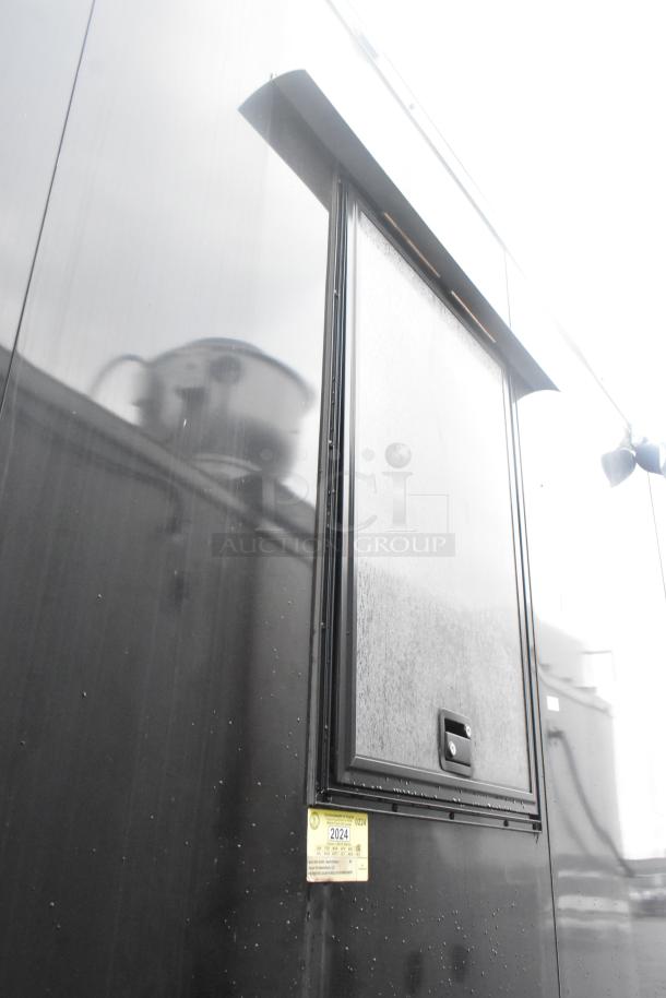 Southern Dimensions 24' retail trailer, black exterior, serving window, 2024 tag. Fully equipped with commercial appliances.