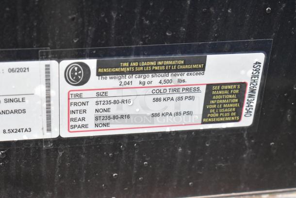 Label on Southern Dimensions 24' trailer detailing tire size and pressure. Front/Rear: ST235-80-R16, 586 KPA (85 PSI).