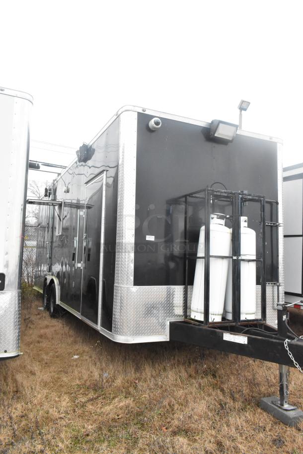 ATX 24' unbranded food trailer, black exterior with utility hook-ups, 2021 model, equipped for mobile kitchen use.