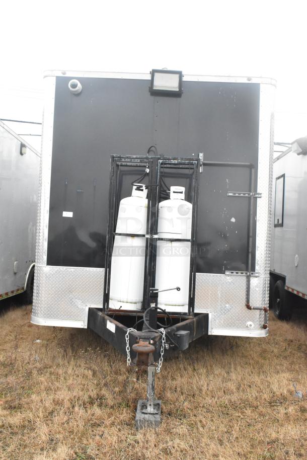 ATX 24' unbranded food trailer, black exterior, dual propane tanks, diamond plate accents. Auction item, new 2021 model.