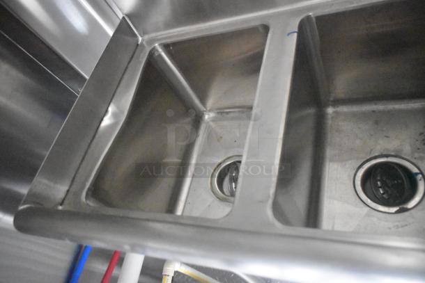 Industrial-grade stainless steel sink in an ATX 24' mobile kitchen trailer, featuring three compartments.