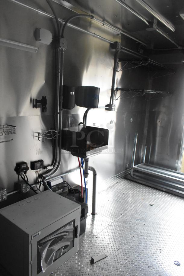 ATX 24' food trailer interior, new in 2021. Features Naks grease hood, fire suppression system, sinks, and wire shelving.