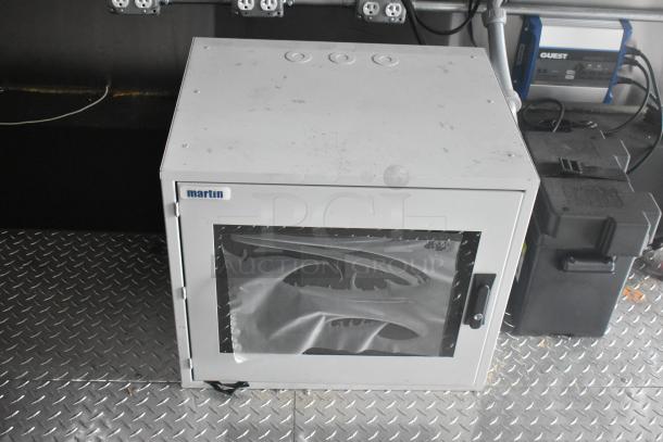 ATX 24' food trailer interior, showing a "martin" branded equipment enclosure on metal flooring.