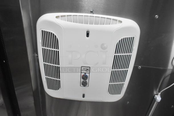 Interior view of ATX 24' food trailer showing a white air vent against stainless steel wall. Features controls with labeled dials.