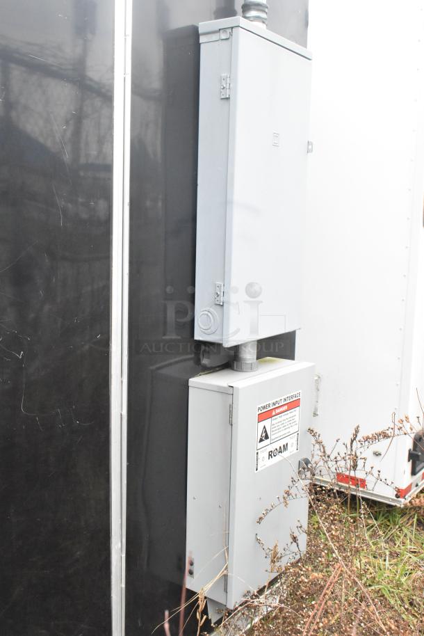Exterior view of the ATX 24' outfitted food trailer showing utility boxes and power input interface.