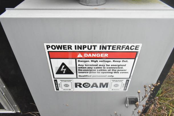 Power input interface warning label on ATX 24' food trailer highlighting high voltage danger and safety instructions.