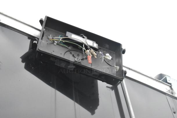 ATX 24' unbranded food trailer, exterior view; wiring and mounting bracket visible.