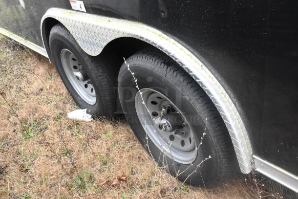 Dual axle wheels on an ATX 24' food trailer with diamond plate fender. Suitable for mobile kitchen use.