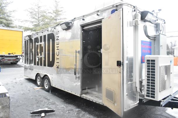 Cruising Kitchens 24' food trailer, fully equipped, stainless exterior, "NBRHD Kitchens" branding, open door, clear title.