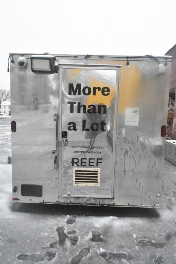 24' Cruising Kitchens food trailer, metallic finish, labeled "More Than a Lot." Features commercial-grade equipment.