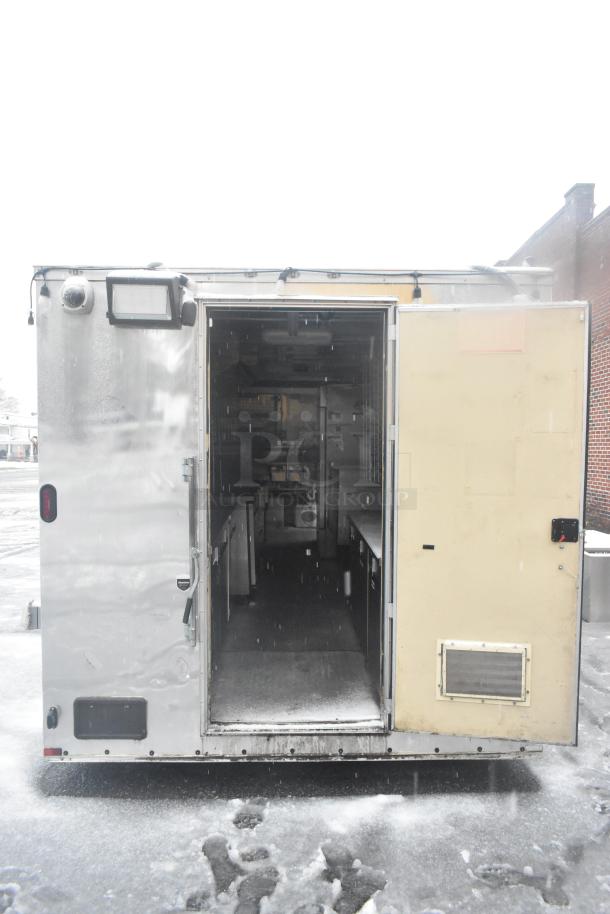 Cruising Kitchens 24' food trailer, fully outfitted mobile kitchen, silver exterior, equipped with commercial-grade appliances.