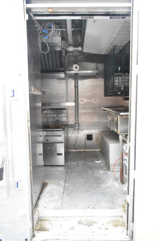Cruising Kitchens 24' food trailer interior, fully equipped with commercial-grade appliances, stainless steel surfaces.