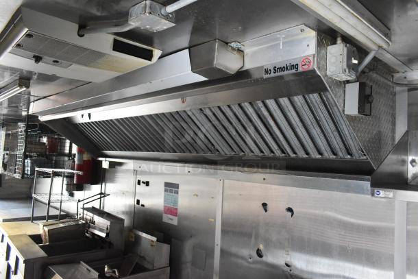 Cruising Kitchens 24' food trailer interior, featuring stainless steel commercial kitchen equipment and "No Smoking" signage.