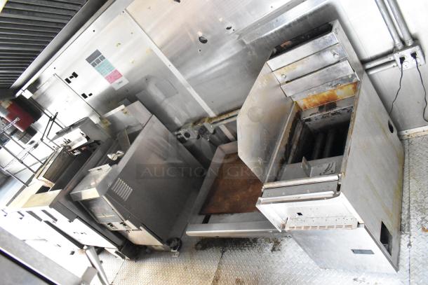 Cruising Kitchens 24' food trailer interior with commercial-grade kitchen equipment, stainless steel fixtures, and diamond plate flooring.