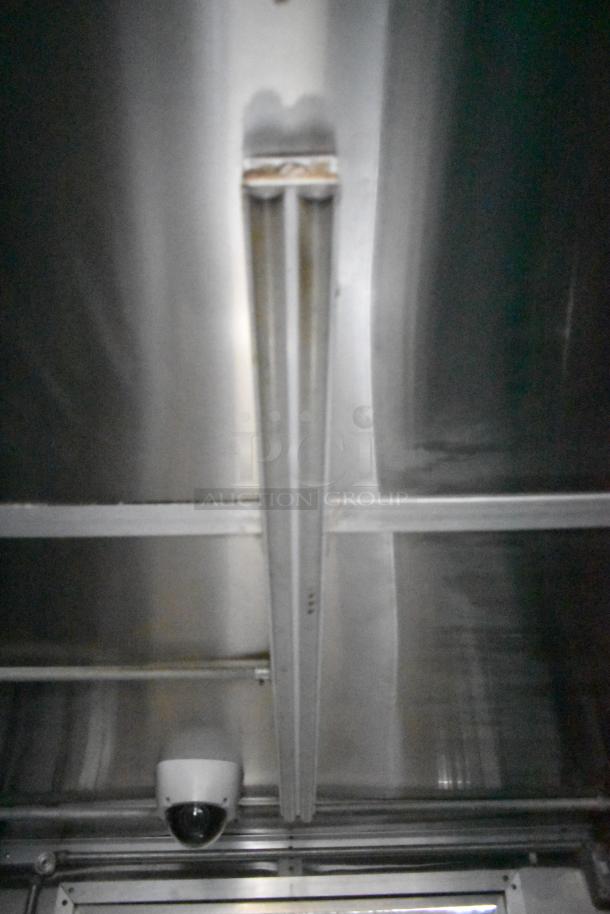 Interior view of Cruising Kitchens 24' food trailer, showing stainless steel ceiling and security camera installation.