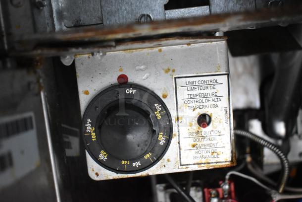 Temperature control panel in Cruising Kitchens food trailer, showing temperature dial and reset button.