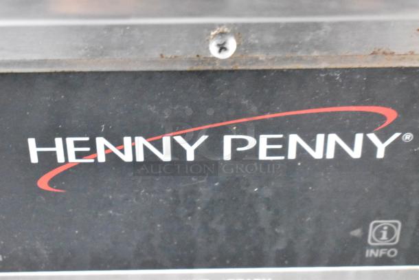 Label of a Henny Penny kitchen appliance, indicating brand presence in the Cruising Kitchens 24' food trailer.