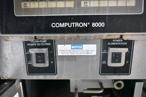 "Computron 8000 control panel with filter pump and power switches, featuring notice on fryer filter system warranty limitations."