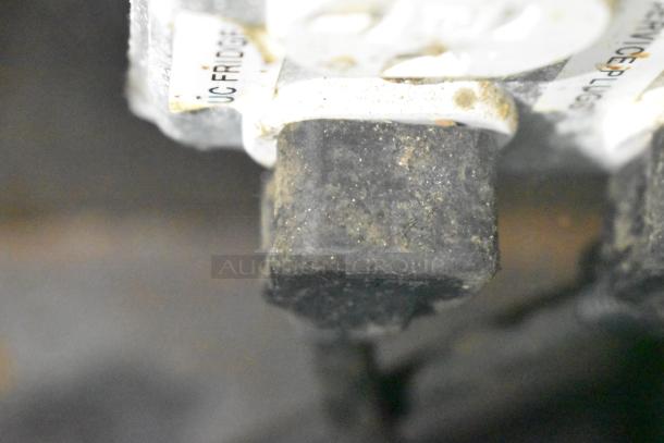 Close-up of a component from a Cruising Kitchens food trailer, showing a labeled connector reading "UC FRIDGE."