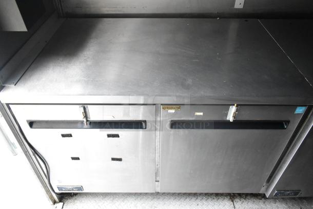 Cruising Kitchens 24' food trailer with stainless steel commercial refrigerator, labeled "Refrigerator." Equipped for diverse concepts.