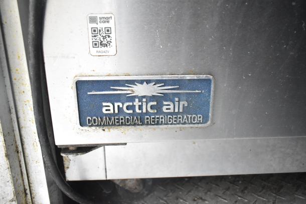Arctic Air commercial refrigerator logo on Cruising Kitchens mobile kitchen. Visible wear on metal surface.