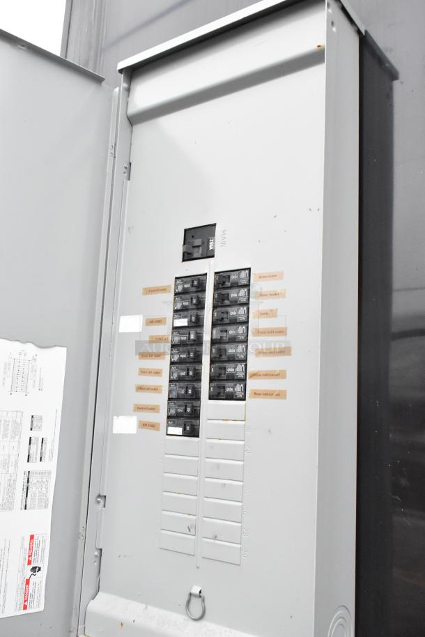 Electrical panel inside Southern Dimensions 24' food trailer, featuring labeled circuit breakers for appliances and outlets.