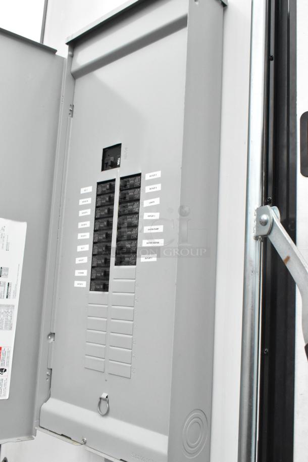 Electrical panel inside a Southern Dimensions 24' trailer with labeled circuit breakers, including AC, lights, and water heater.