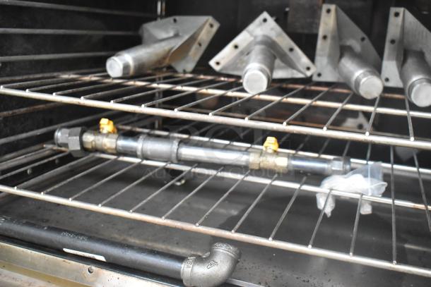 Vulcan VC6GD-SEFCAM convection oven interior, metal racks, thermostatic controls, gas fittings visible. Commercial use.