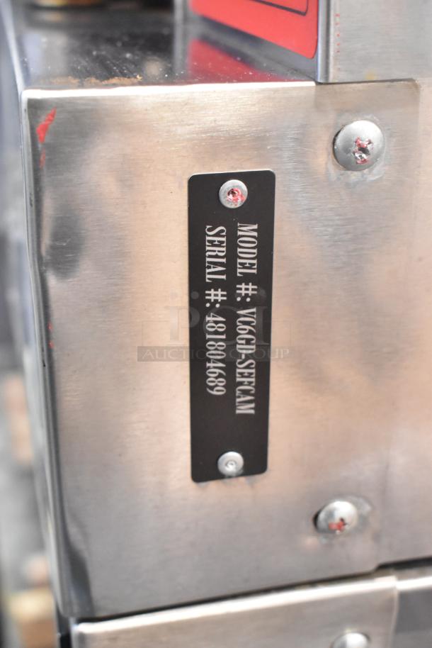 Stainless steel label with Vulcan VC6GD-SEFCAM model and serial numbers on a commercial convection oven.