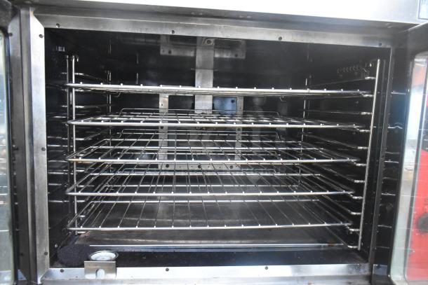 Vulcan VC6GD-SEFCAM5 convection oven interior with metal racks, stainless steel, gas-powered, view-through doors, thermostatic controls.