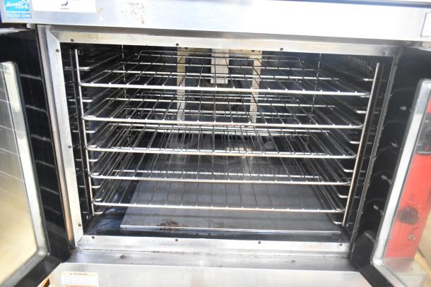 Vulcan VC6GD-SEFCAM5 stainless steel gas convection oven with view-through doors, metal racks, and thermostatic controls.