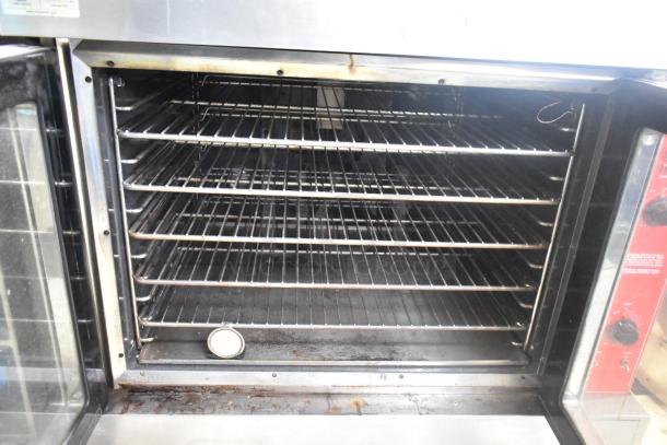 Vulcan VC6GD-SEFCAM stainless steel gas convection oven with view-through doors, metal racks, and thermostatic controls.