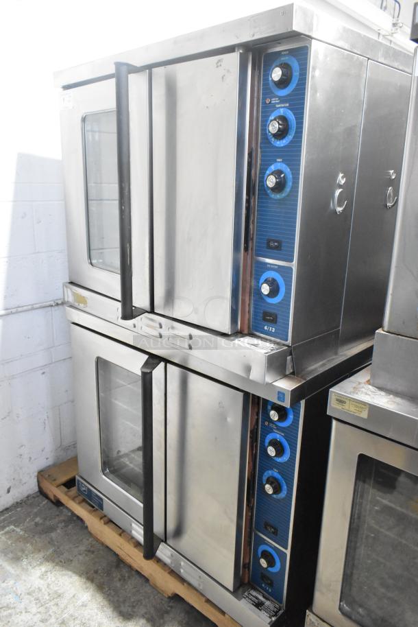 Duke 6/13 stainless steel commercial convection ovens, stacked, gas powered, view-through and solid doors, metal racks, thermostatic controls.